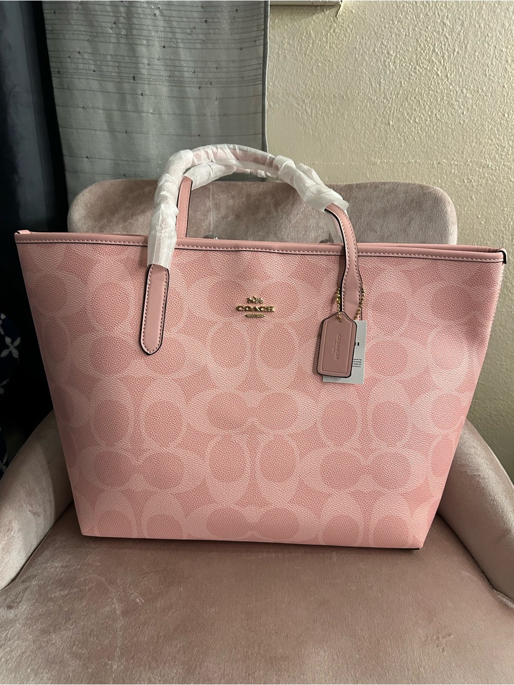 Coach Powder Pink Signature Canvas Tote with Gold Logo.